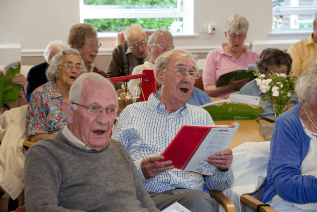 Seniors singing together in a TbT program